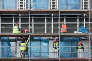 Construction workers on a scaffold.
