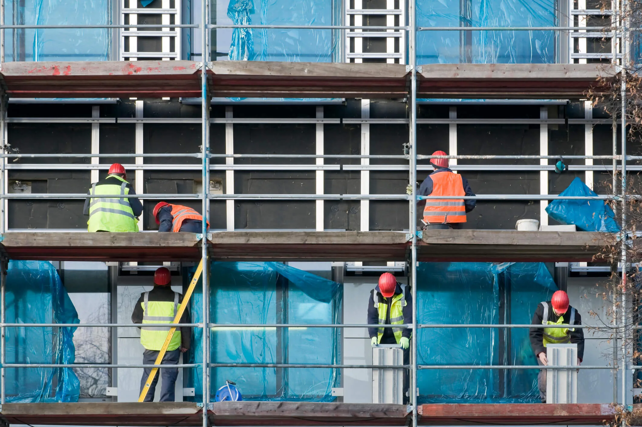 Construction workers on a scaffold.