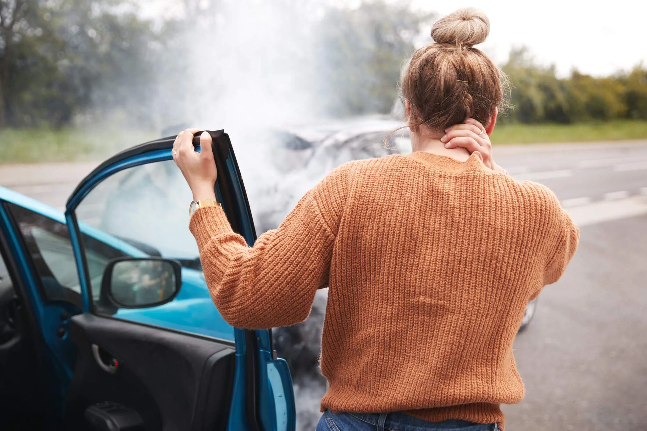 Woman holding her neck after a car accident