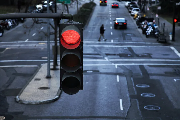 Red light hanging above a paved street in the city