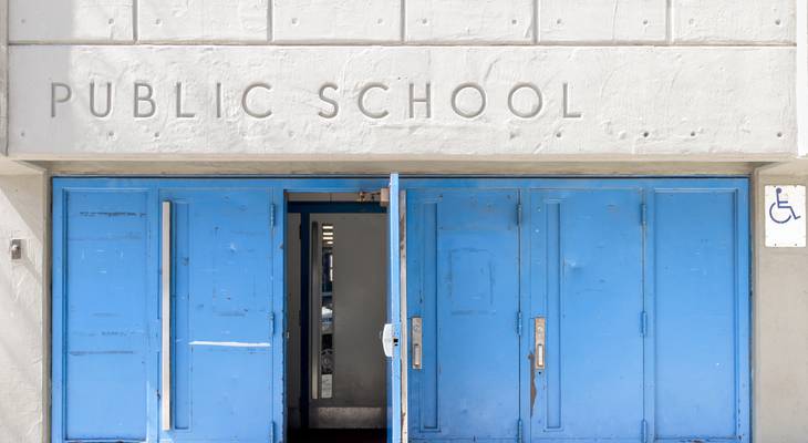 The swinging entry doors of a New York City elementary school building