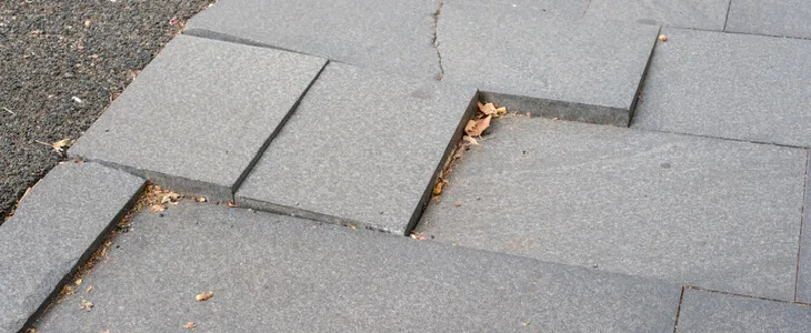 Uneven sidewalk pavement on a street